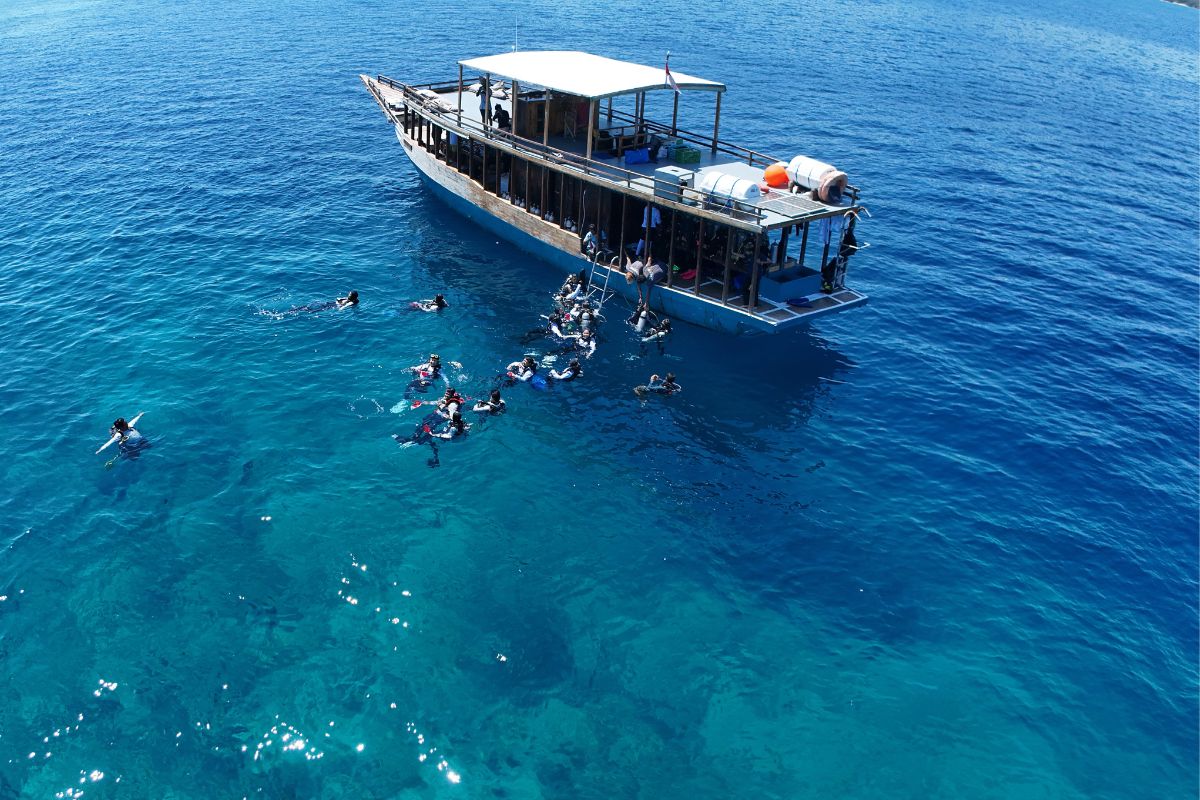 Divers preparing equipment on dive boat in Labuan Bajo