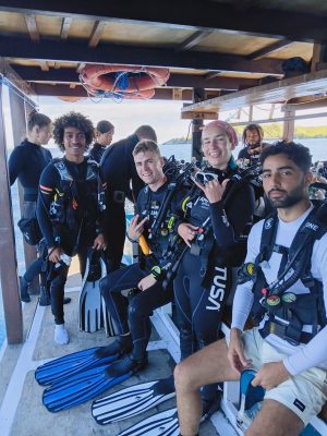Maria Seascape guest reviews team and divers on deck celebrating safe diving in Labuan Bajo